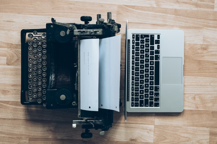 A typewriter and laptop.