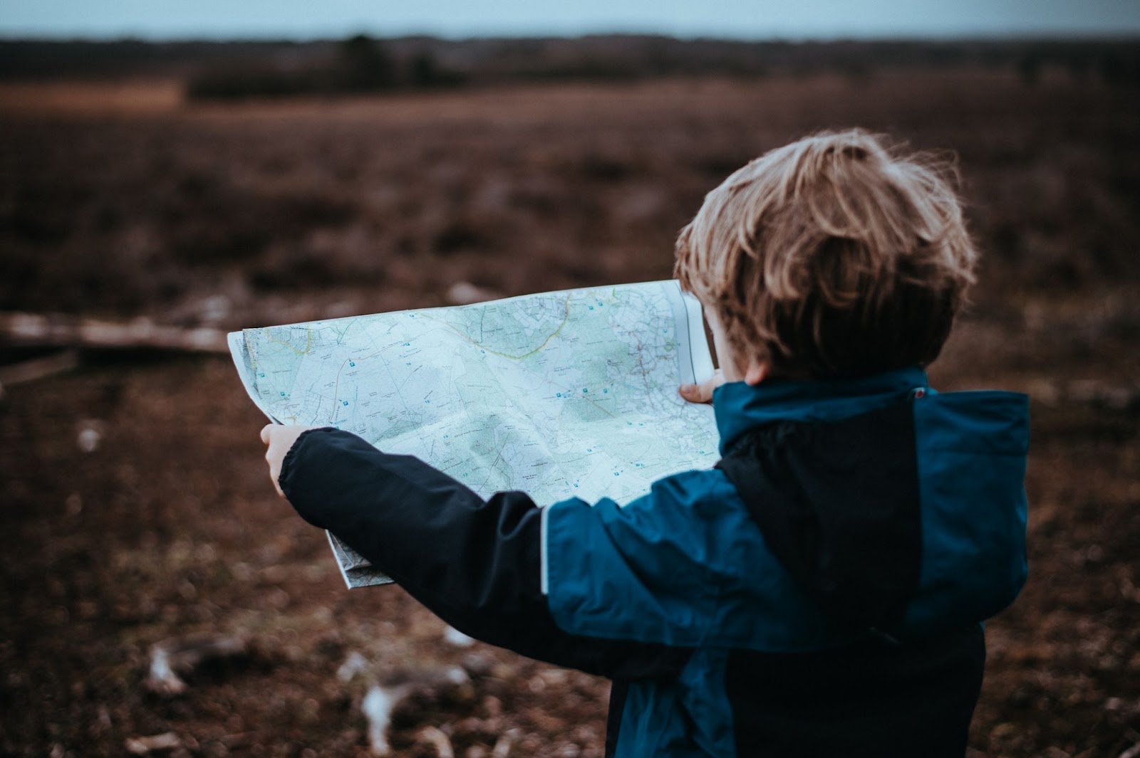 child holding a map looking for family friendly activities