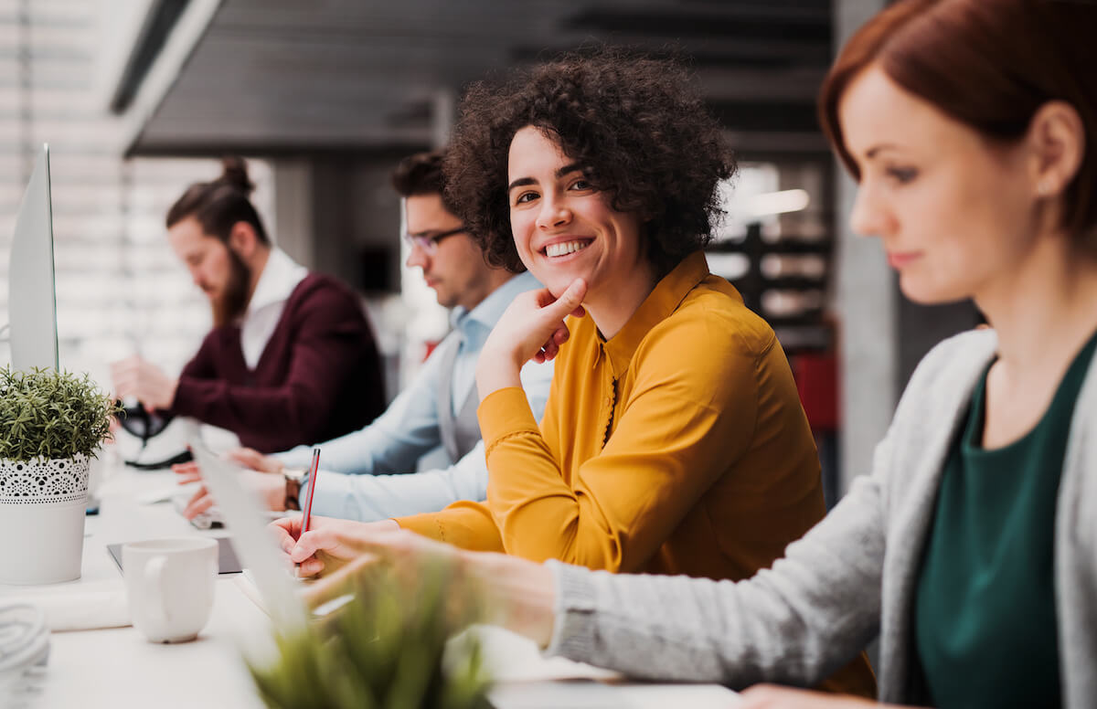 Tracking patients: employee smiling at the camera