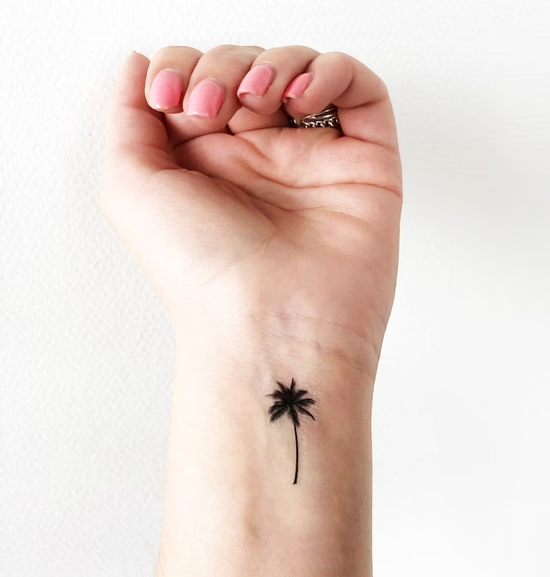 Full view of how a beautiful wrist palm tree tattoo looks like 