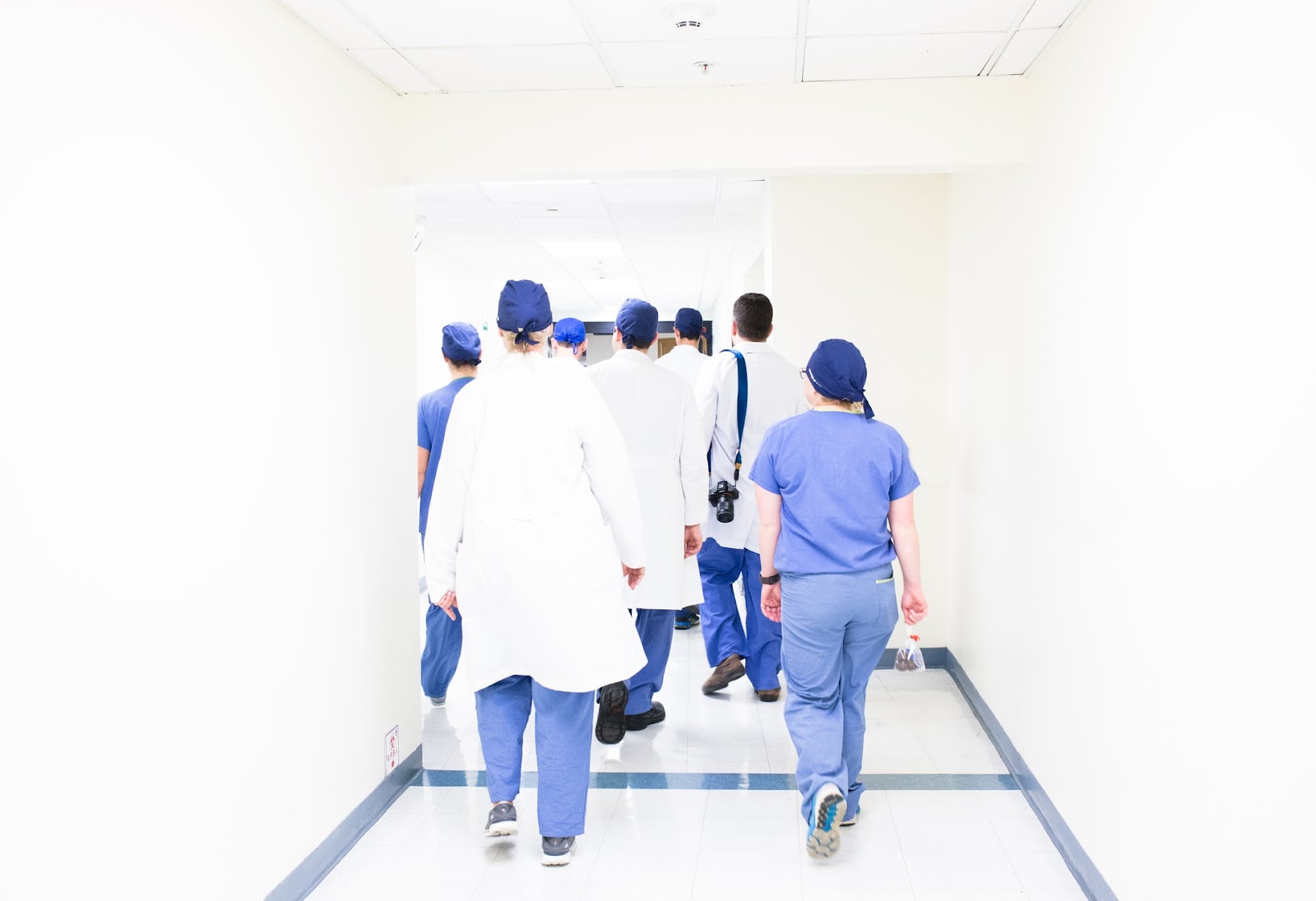 Gift Ideas for Nurses; a group of nurses and doctors walking in a brightly lit passage