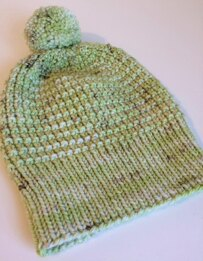 light green knit hat lying flat