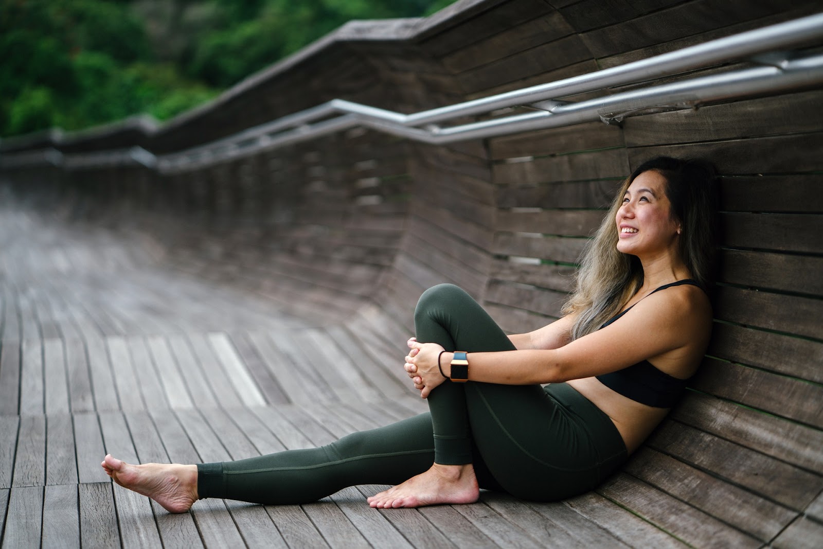 Woman sitting on a wooden walkway
