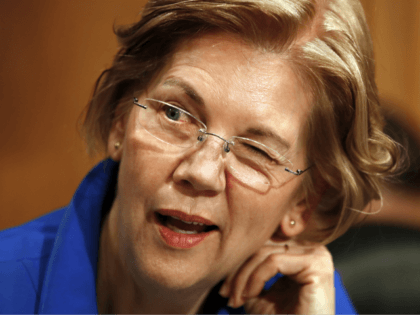 Sen. Elizabeth Warren, D-Mass., winks as she jokes with other senators on the Senate Banking Committee ahead of a hearing on the nomination of Marvin Goodfriend to be a member of the Federal Reserve Board of Governors, Tuesday, Jan. 23, 2018, on Capitol Hill in Washington. (AP Photo/Jacquelyn Martin)