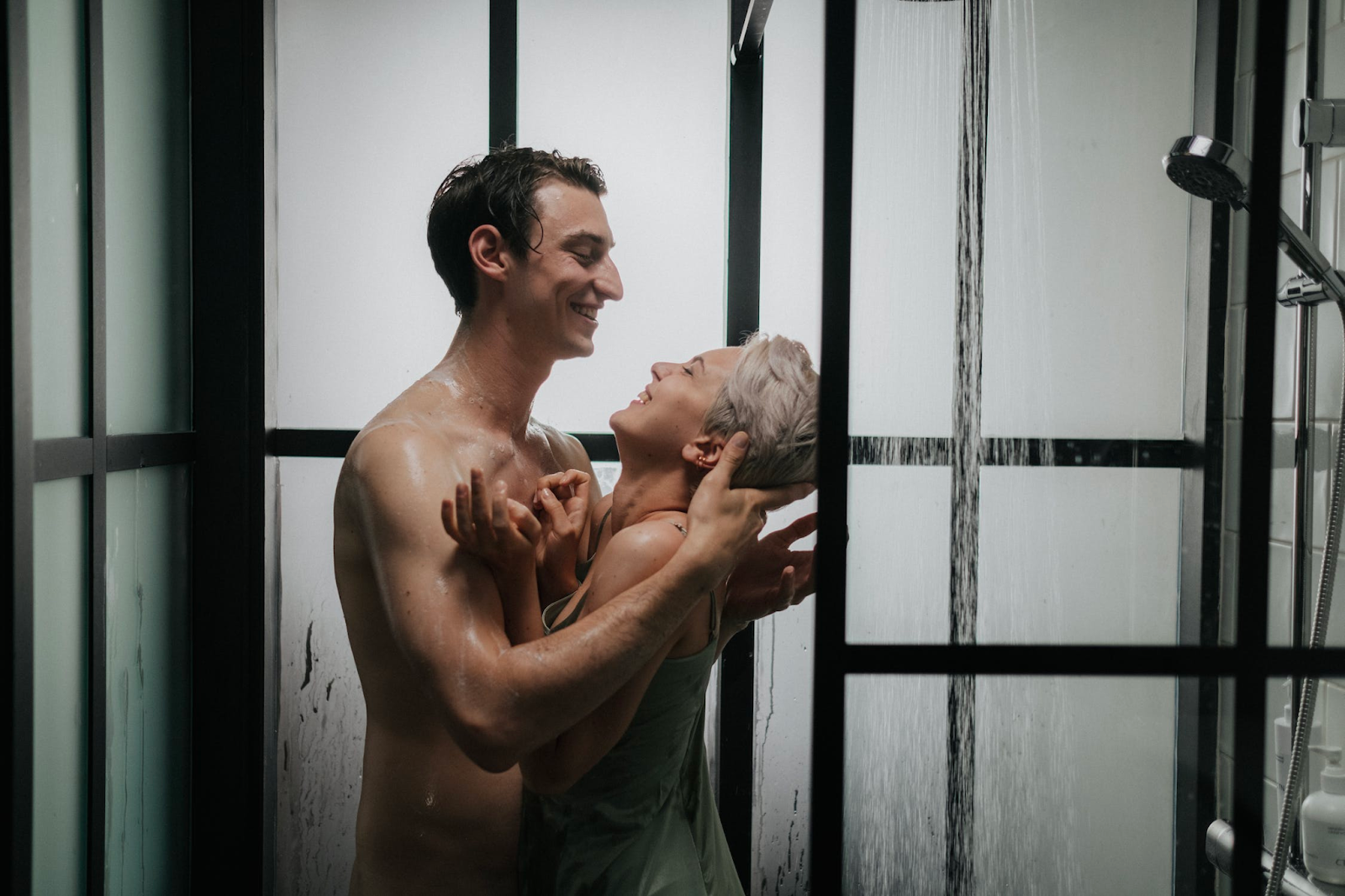An attractive couple looking at each other in the bathroom