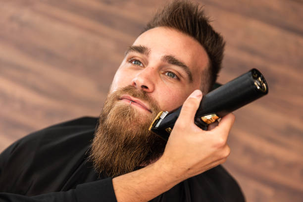 Man receiving a beard trim in a barber shop