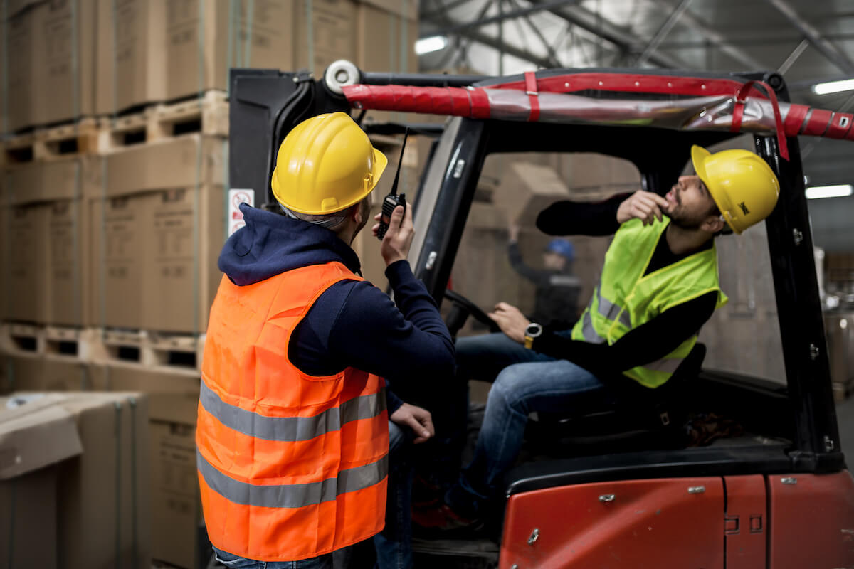Claims management systems: 2 workers checking something in a warehouse