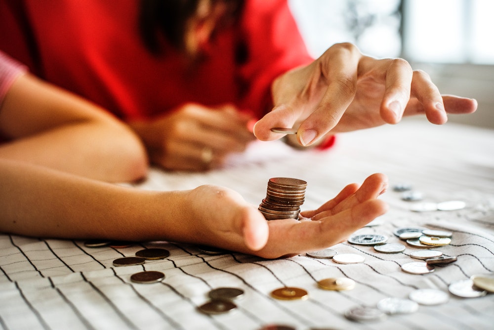 person holding coins