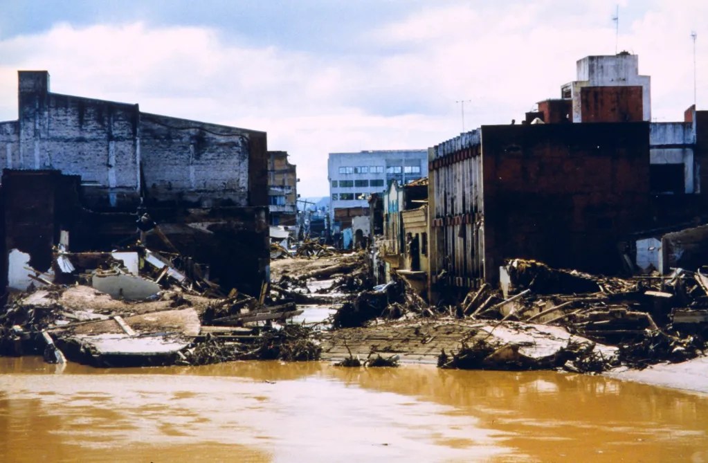 Buildings along a muddy river collapsed.