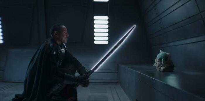 Moff Gideon threatening Grogu with his darksaber