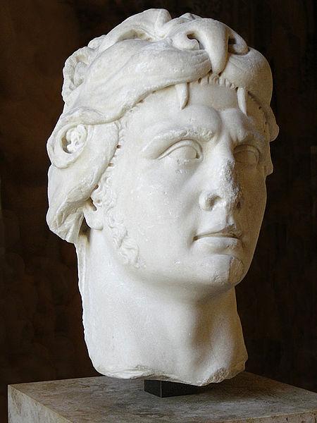 Bust of Mithridates in the lion headdress of Hercules. It is made of out white marble.