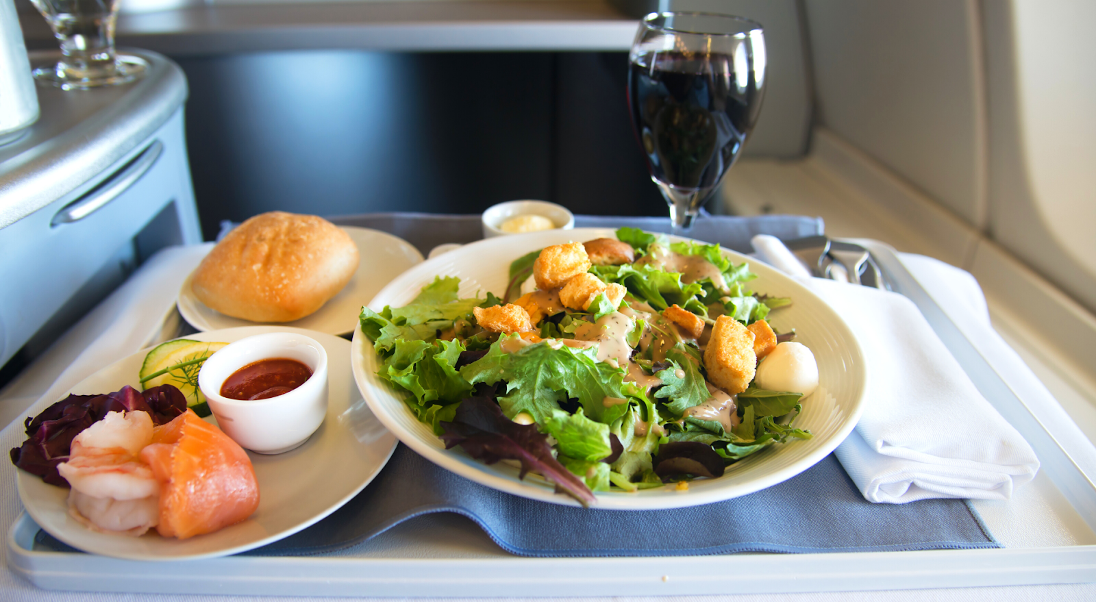 business class meal with salad and shrimp