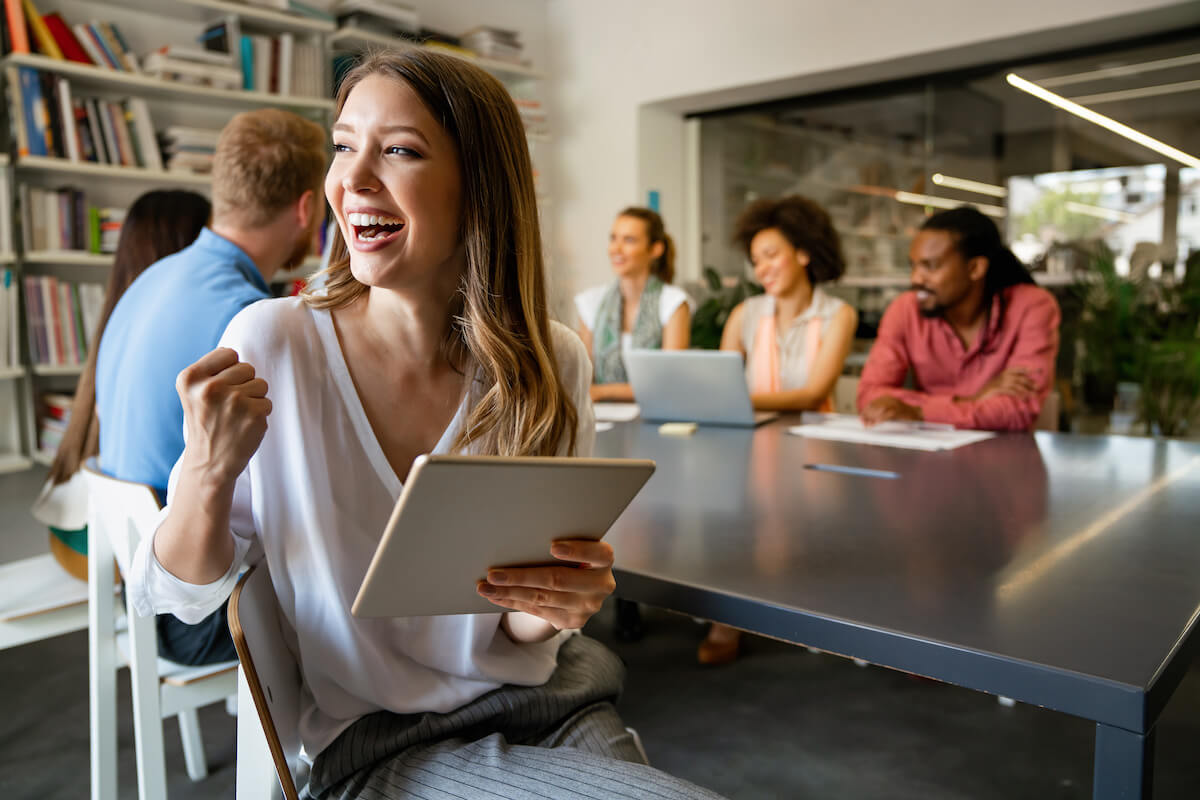 Engagement therapy: entrepreneur happily holding a tablet