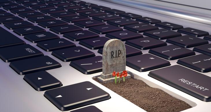 Image of a grave on a laptop computer keyboard.