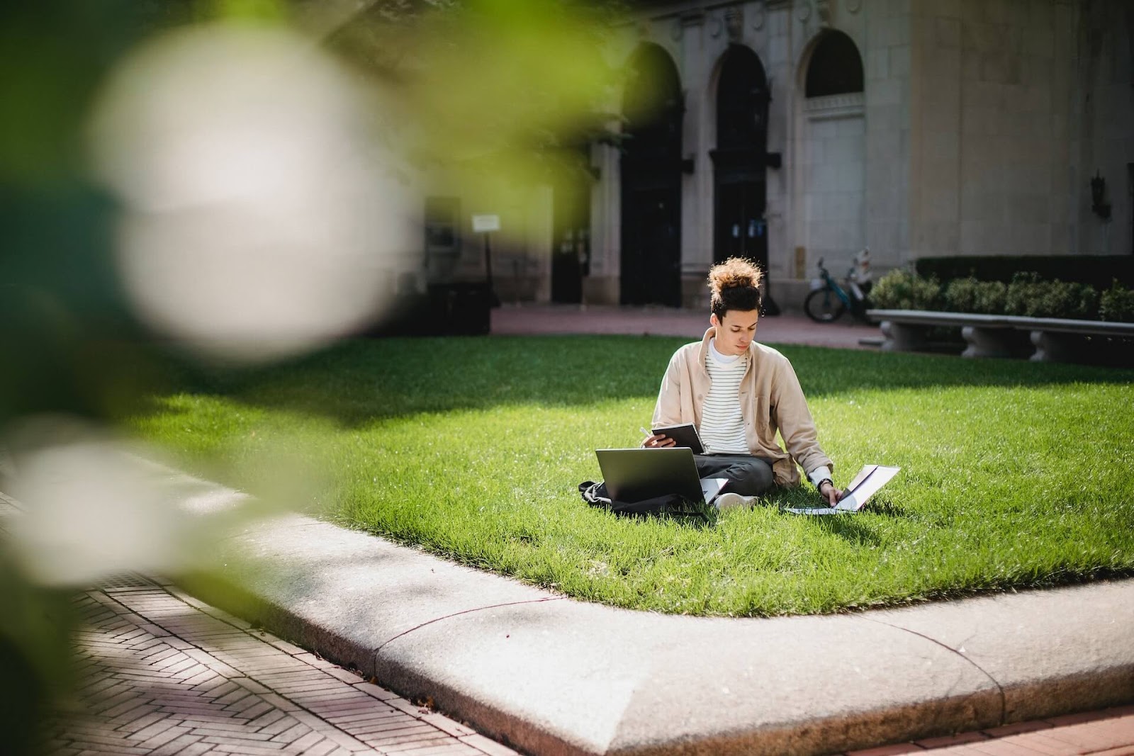Student sitting on the lawn on campus