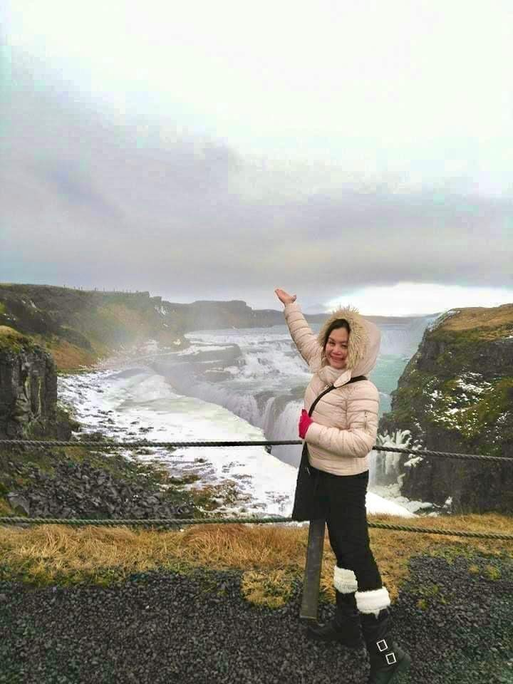Image of Candy in Iceland with a waterfall in the background