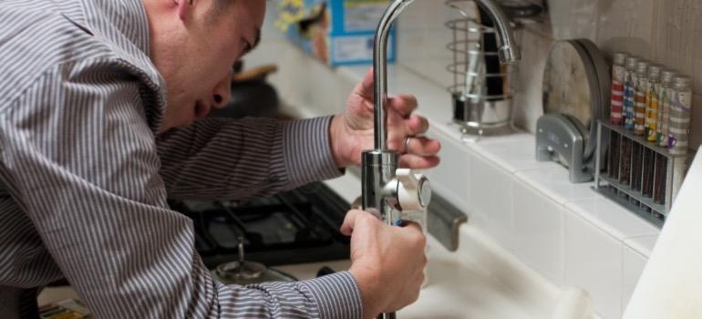 A plumber repairing a sink.