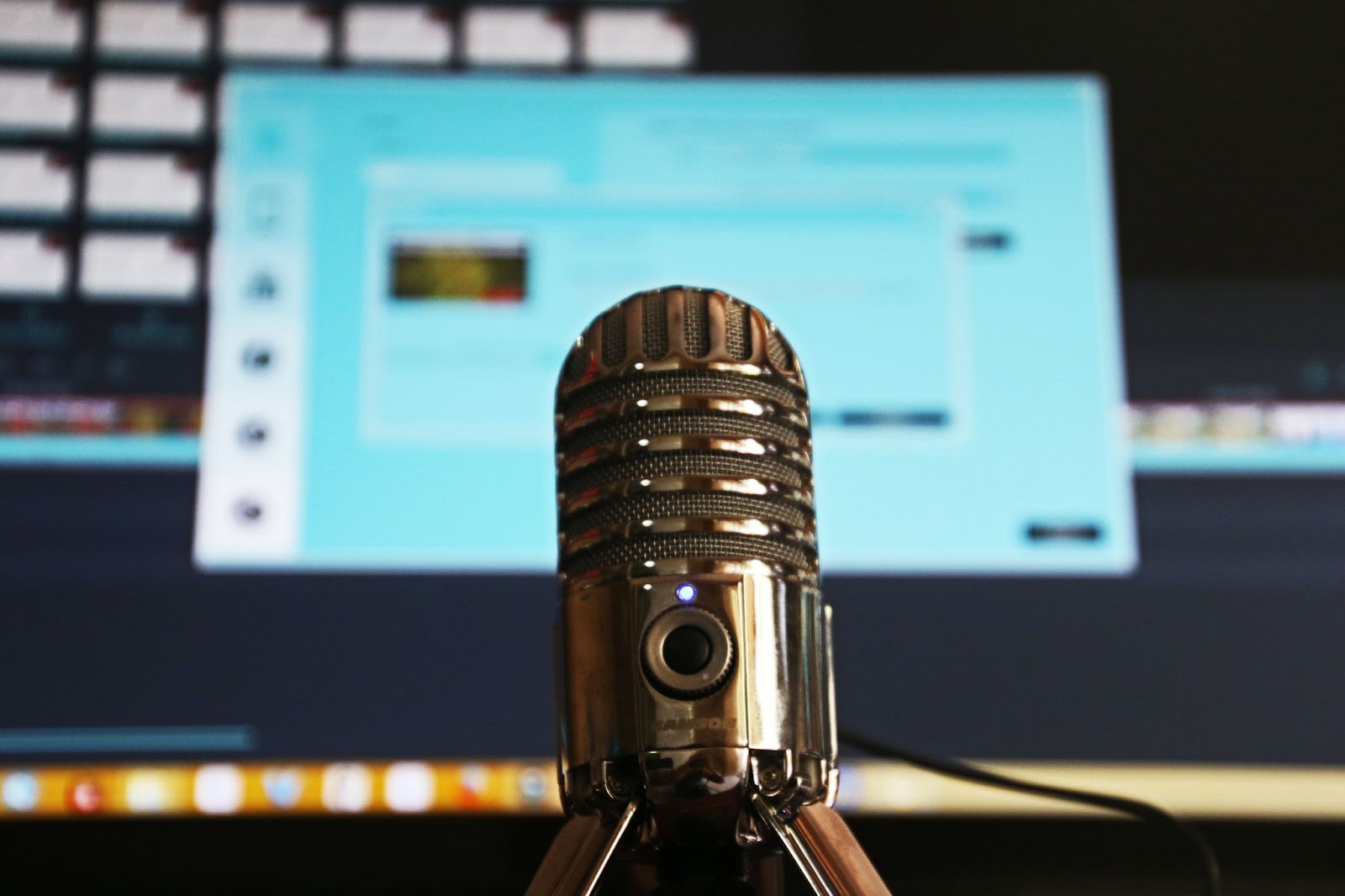 A photo of a gray stainless steel condenser microphone