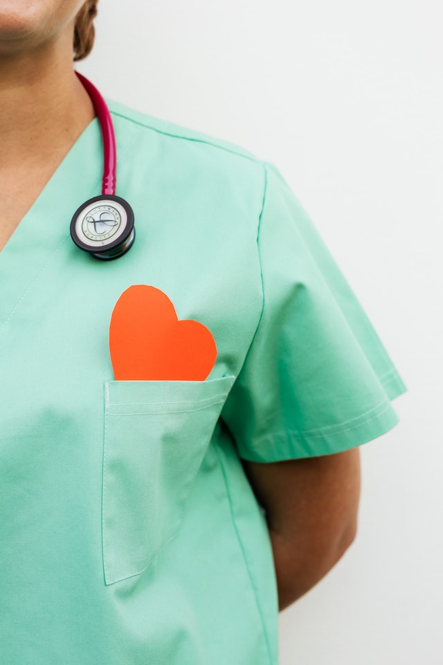 A Nurse with a heart pin on uniform.
