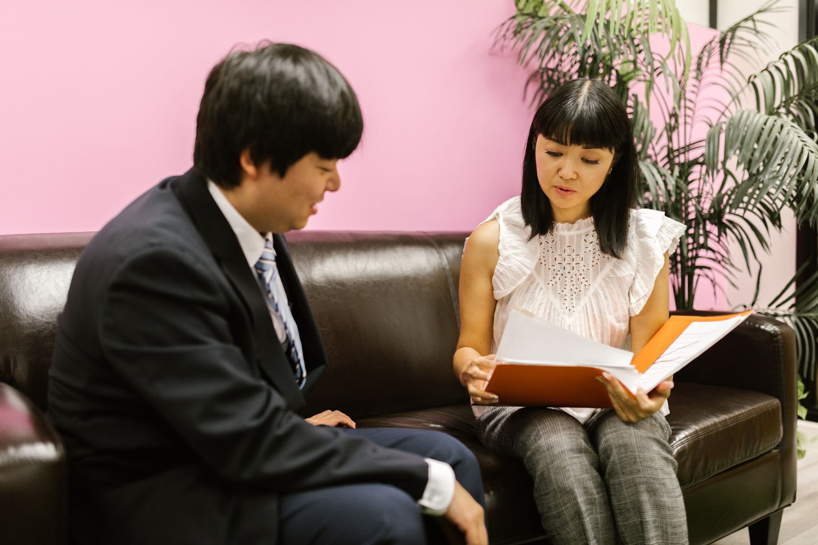 A hiring manager and a candidate discussing the candidate's resume during an interview
