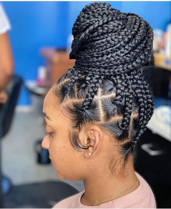 Lady shops of her large knotless braids in a bun