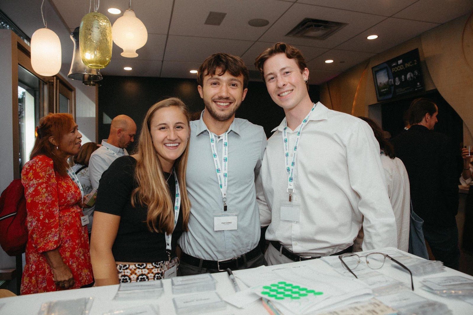 Three young people smile and pose for a picture. 