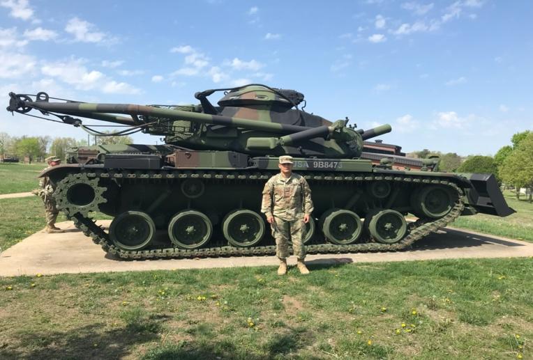 A military vehicle on a dirt roadDescription automatically generated
