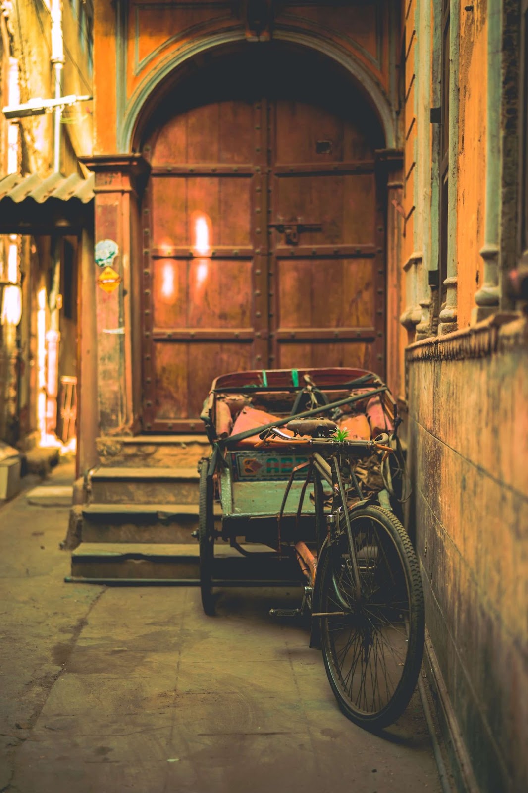 1 day in Delhi. This is an image of a bicycle against a wooden door at Chandni Chowk.