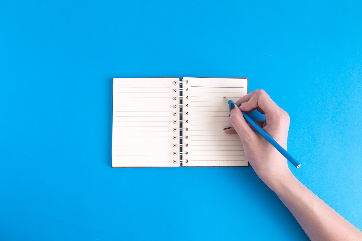 How to organize notes: person using a pencil and a notebook