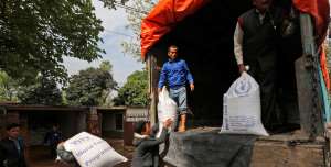 File: Nepalese people unload relief material from a truck at earthquake affected Dhadingbesti, in Nepal, Wednesday, April 29, 2015.
