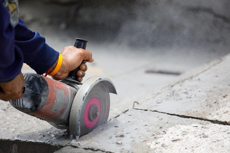 Contractor cutting with an angle grinder