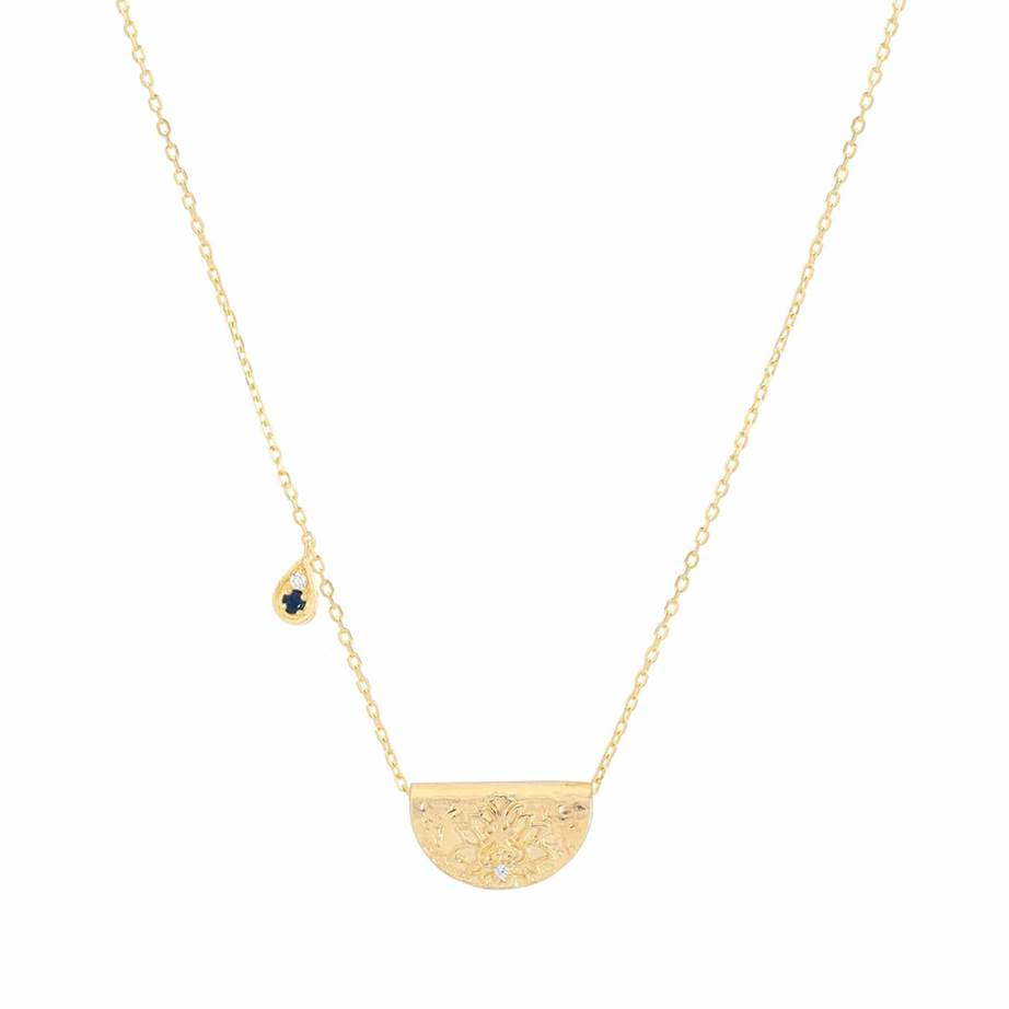 A gold necklace with a pendant and a blue gem

Description automatically generated