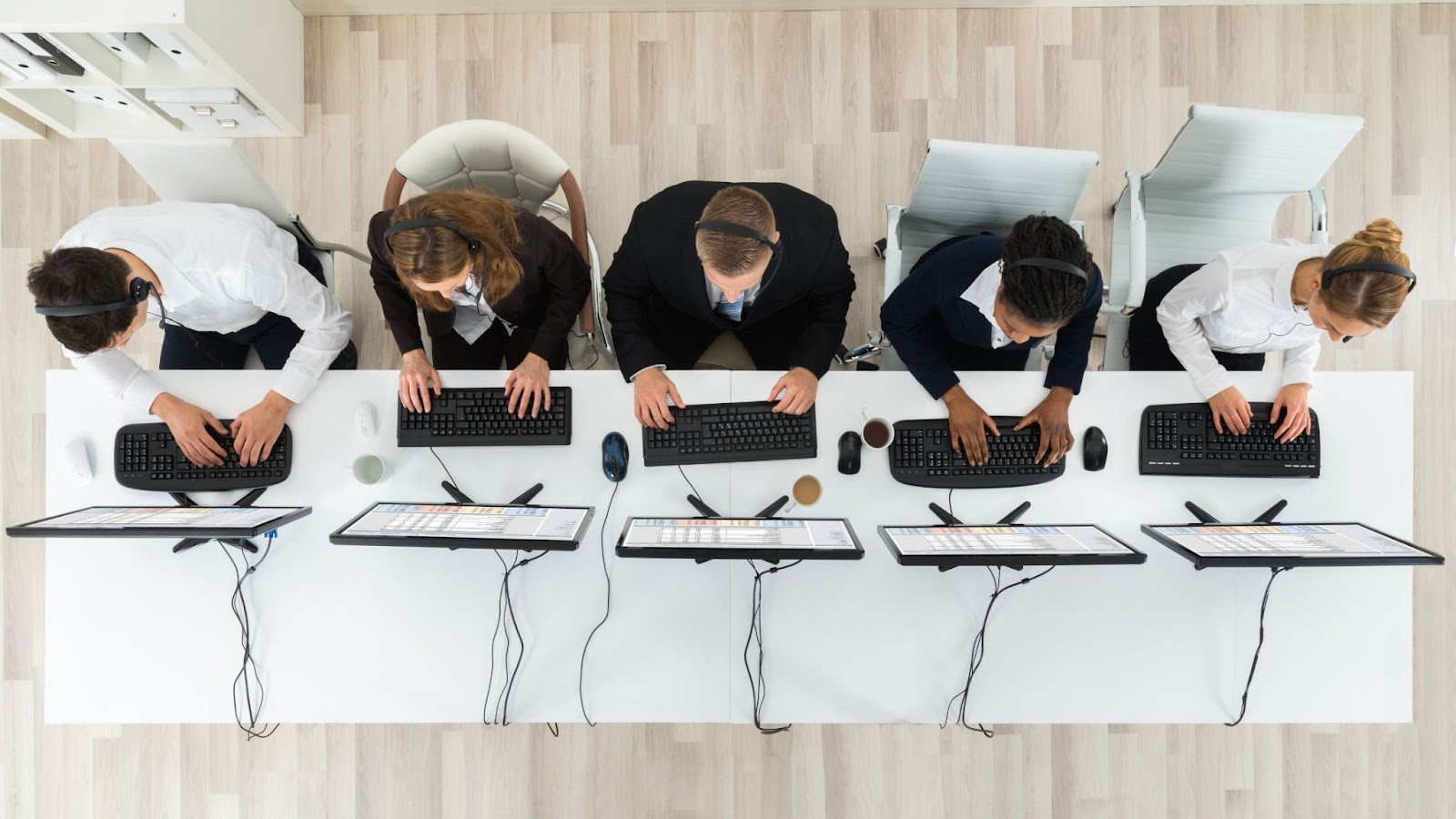 An overhead shot of call center outsourcing agents busy working. 