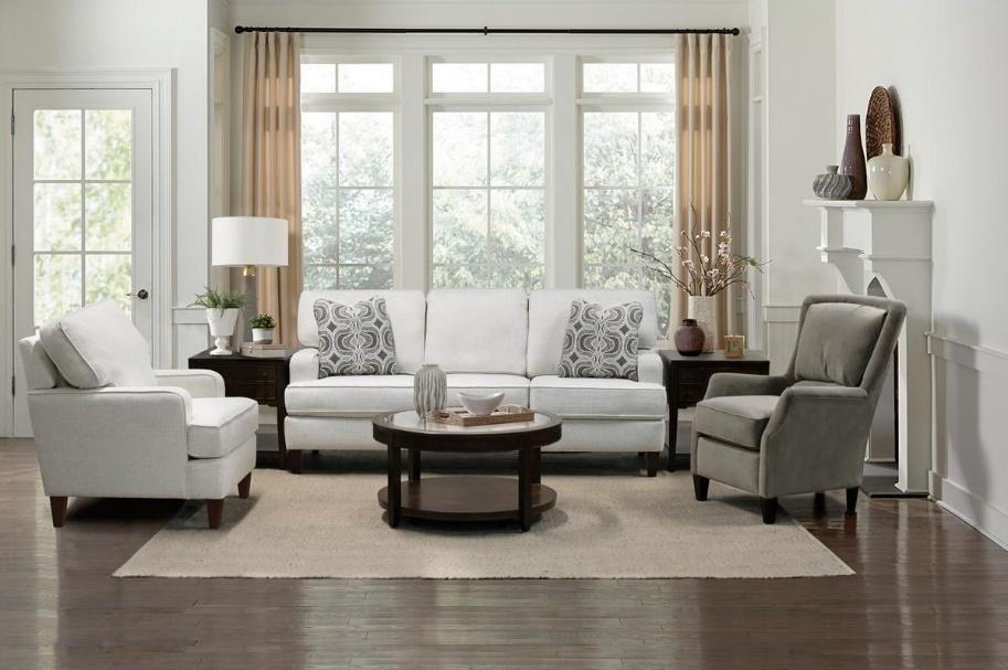 A living room set with a white sofa, a coffee table, and club chairs
