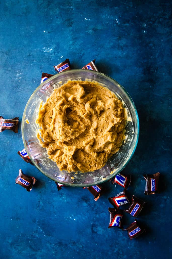 bowl of peanut butter cookie dough on blue background