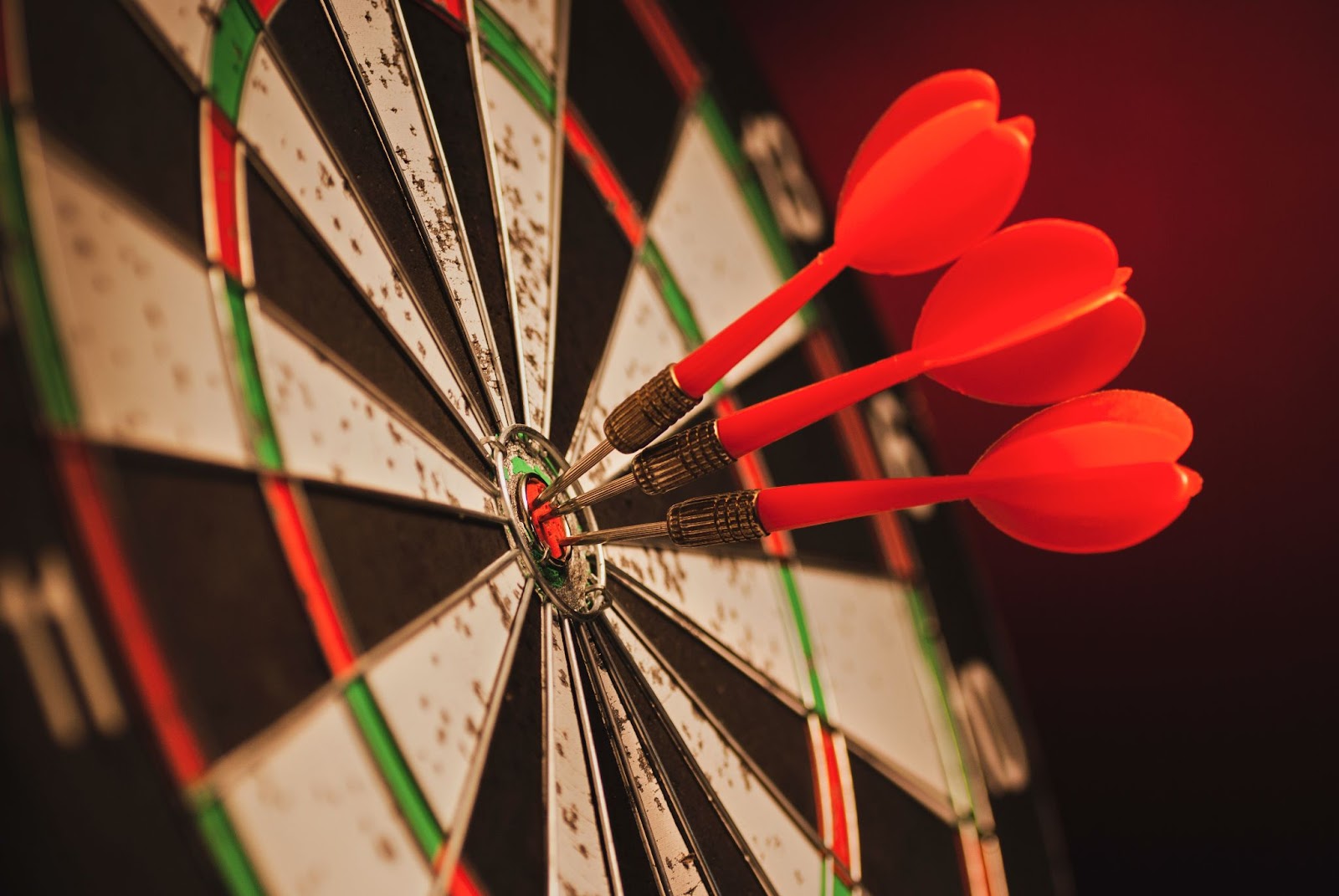 Three darts in the center of a bullseye representing entrepreneurial operating system advantages.