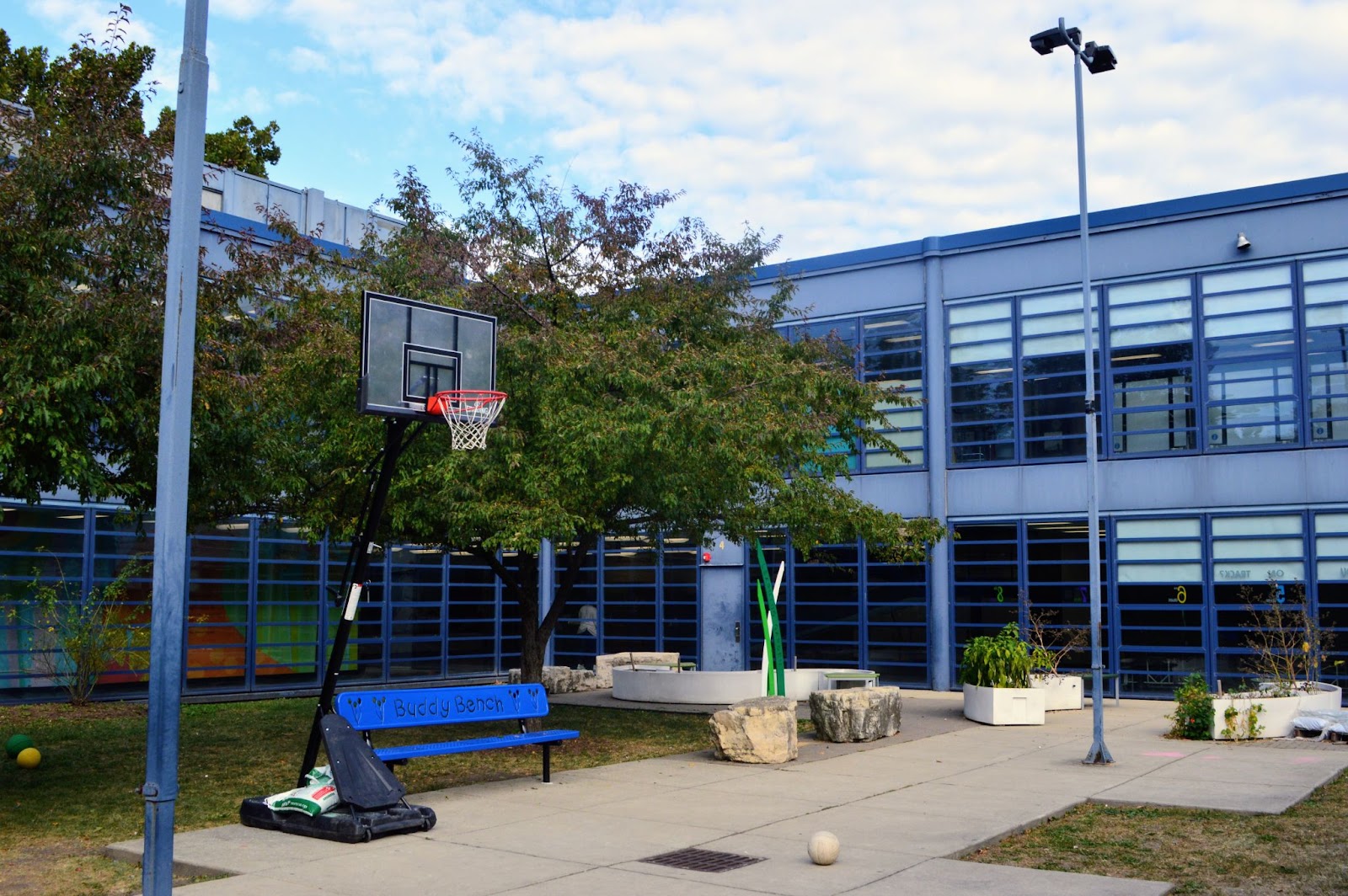 A school courtyard with a basketball hoop