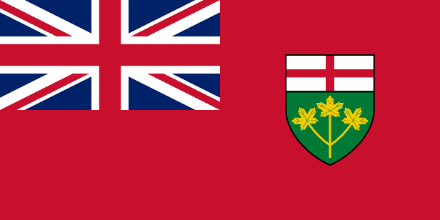 A red flag with a large Union Jack in the upper left corner and a shield in the centre-right