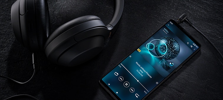 Wired headphones plugged into the 3.5mm audio jack on the Xperia 1 IV