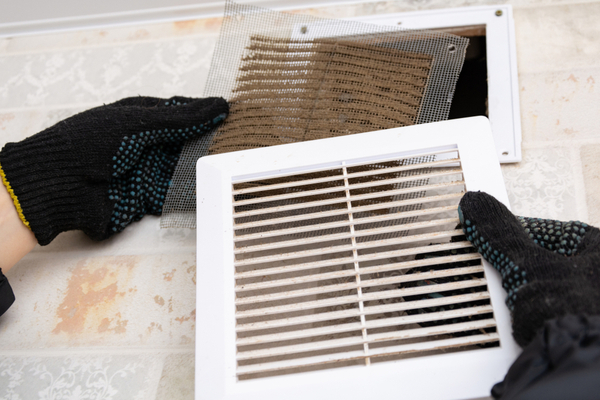 hvac technician cleaning dirty vents