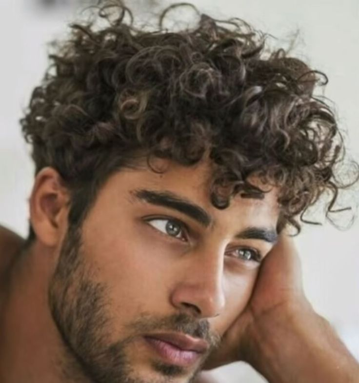 A guy with curly male hairstyle