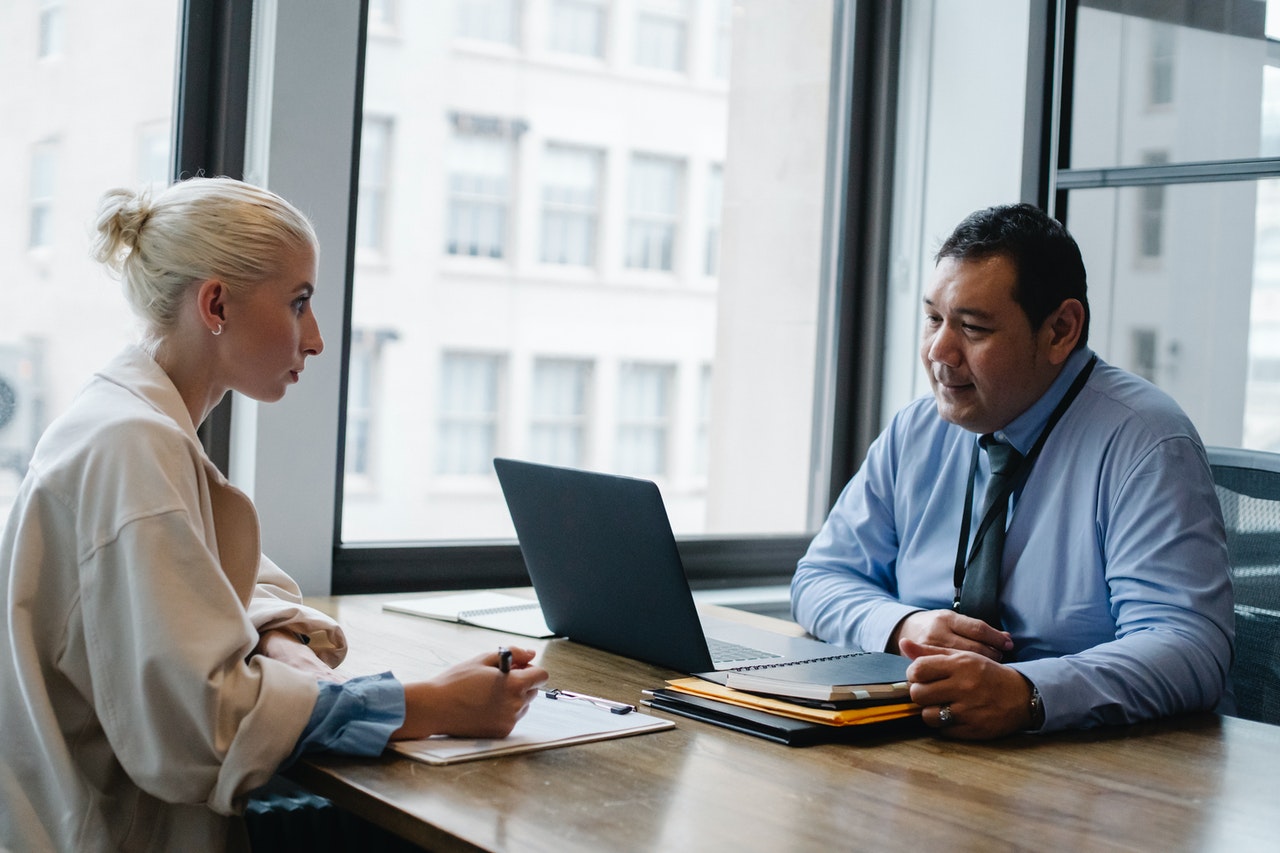 Interviewer meeting with a potential job candidate in an office setting