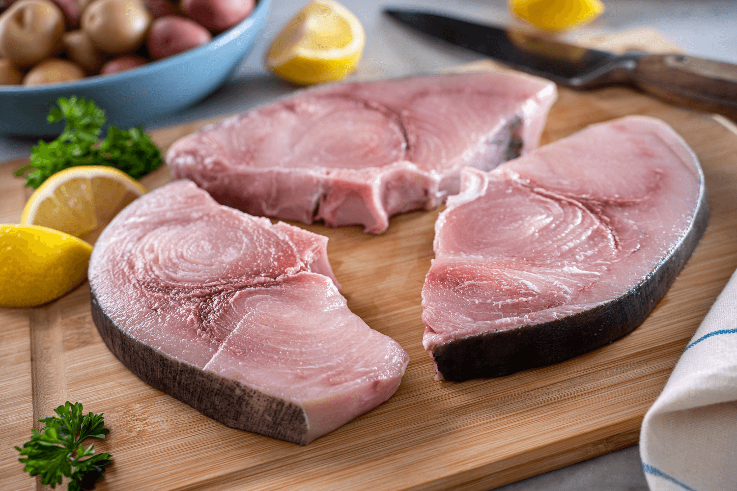 Swordfish steaks on a cutting board