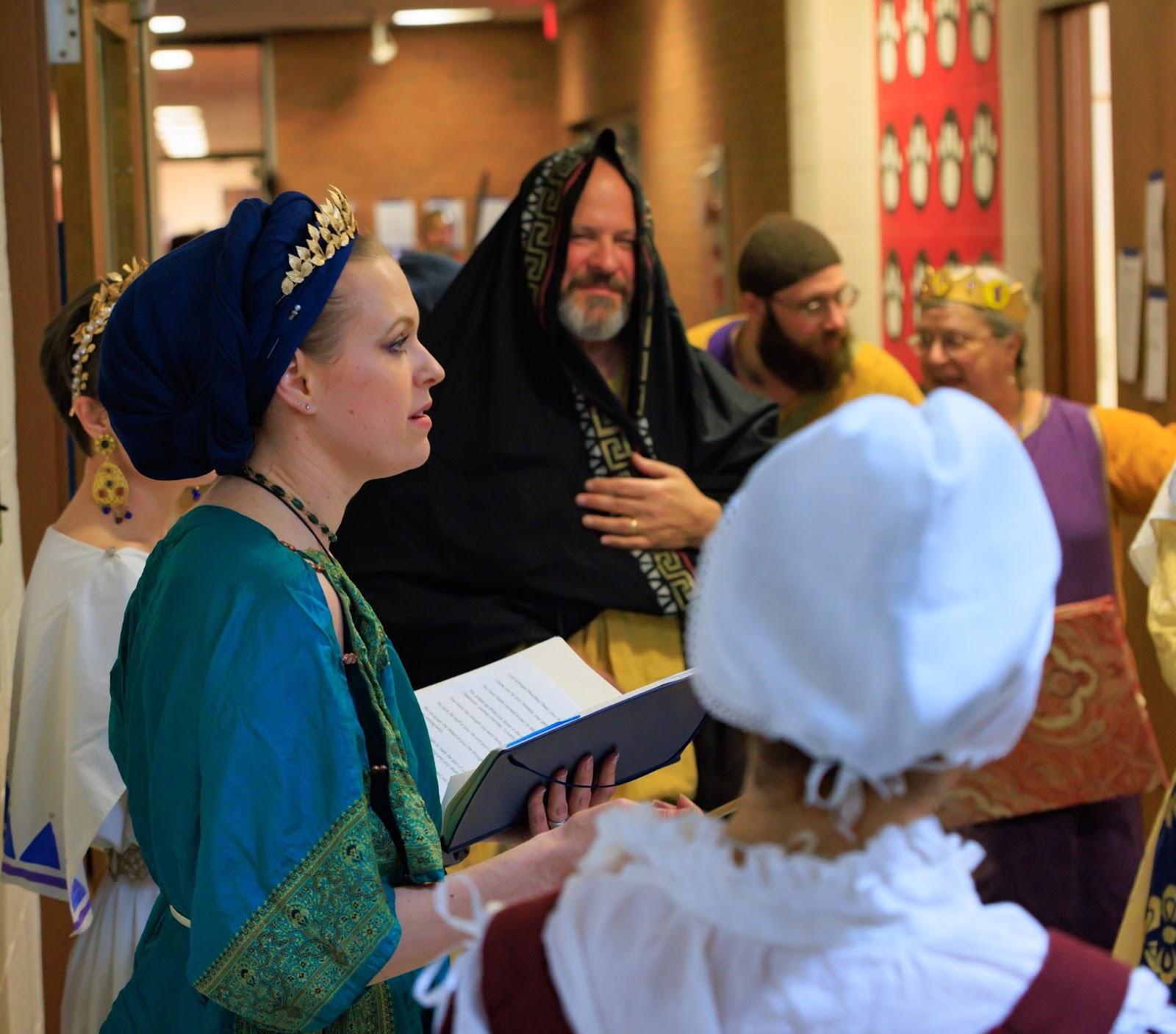 Meisterin Kolfinna, left, spins the thread of my life as Clotho in her portion of the pageant. Ollamh Ruaidrhi, p0laying Atropos center, waits to cut my previous times by taking my apprentice belt. Photo by Thomas Beebe.