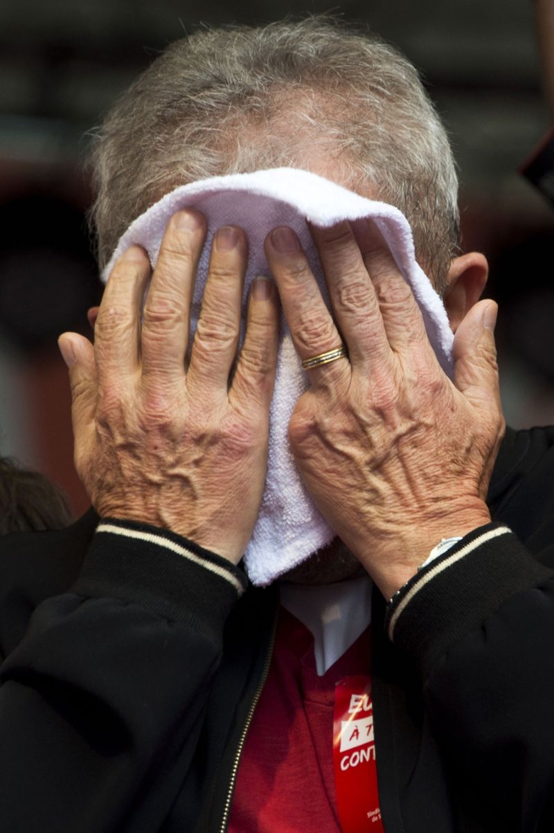 Former Brazilian President Luiz Inacio Lula da Silva wipes his face as he participates in the May Day celebrations in Sao Paulo, Brazil, on May 1, 2015. AFP PHOTO / Nelson ALMEIDA (Photo credit should read NELSON ALMEIDA/AFP/Getty Images)