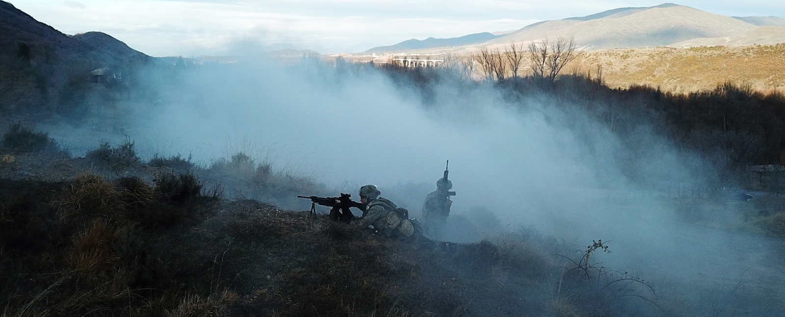 GOE operatives in combat training in a foggy hillside.
