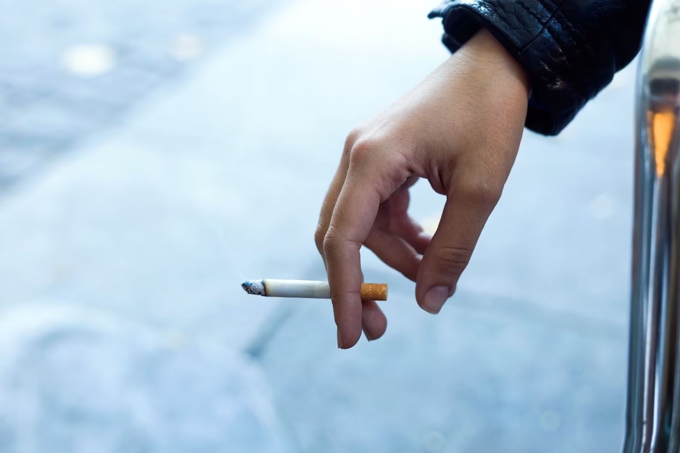 woman's hand with cigarette in the street