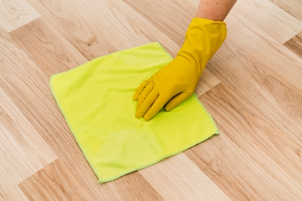 woman-with-rubber-glove-cleaning-floor