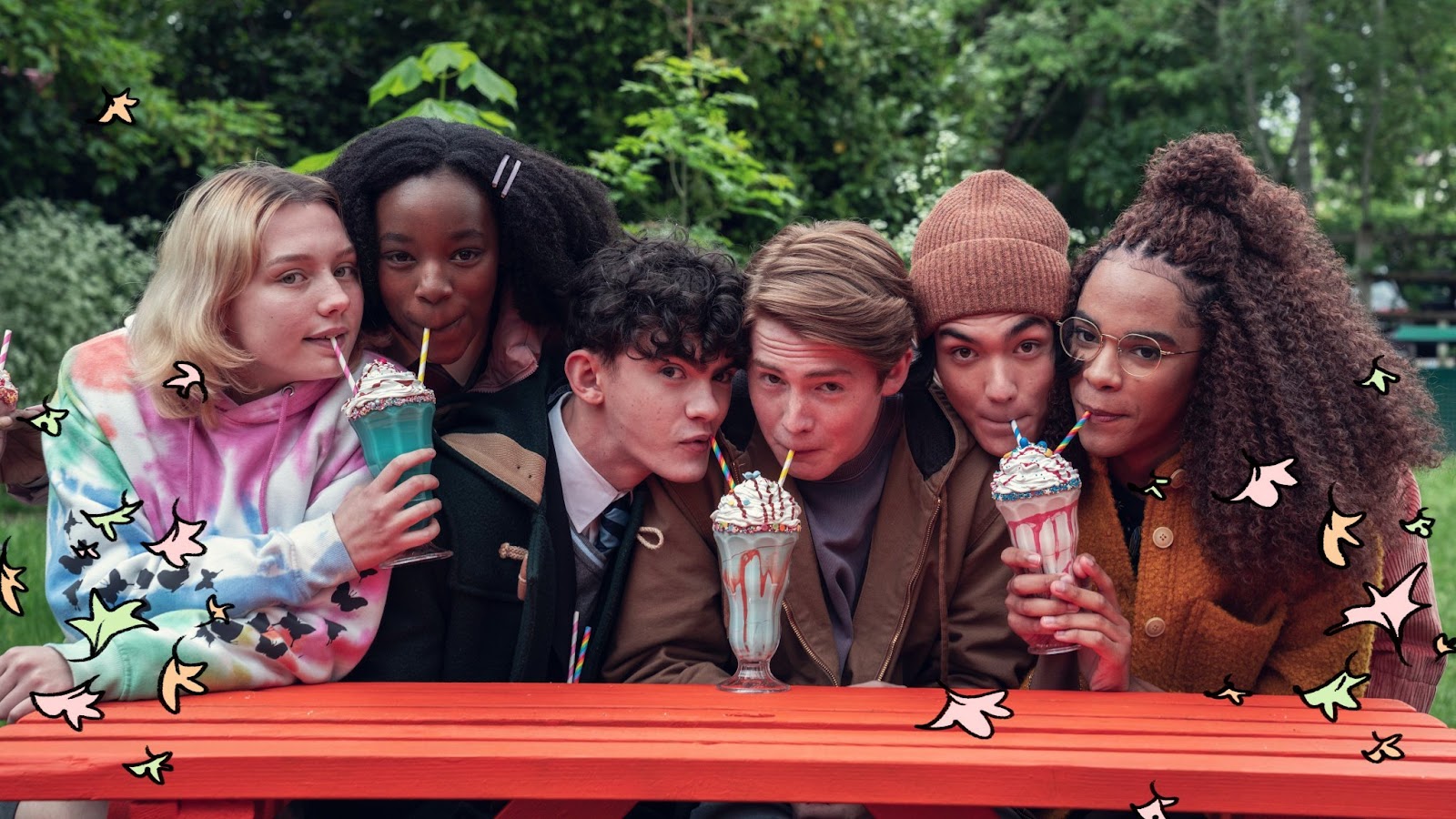Elenco principal de Heartstopper com os três casais juntos tomando milkshakes. Da esquerda para a direita: Darcy e Tara, Charlie e Nick, Tao e Elle.
