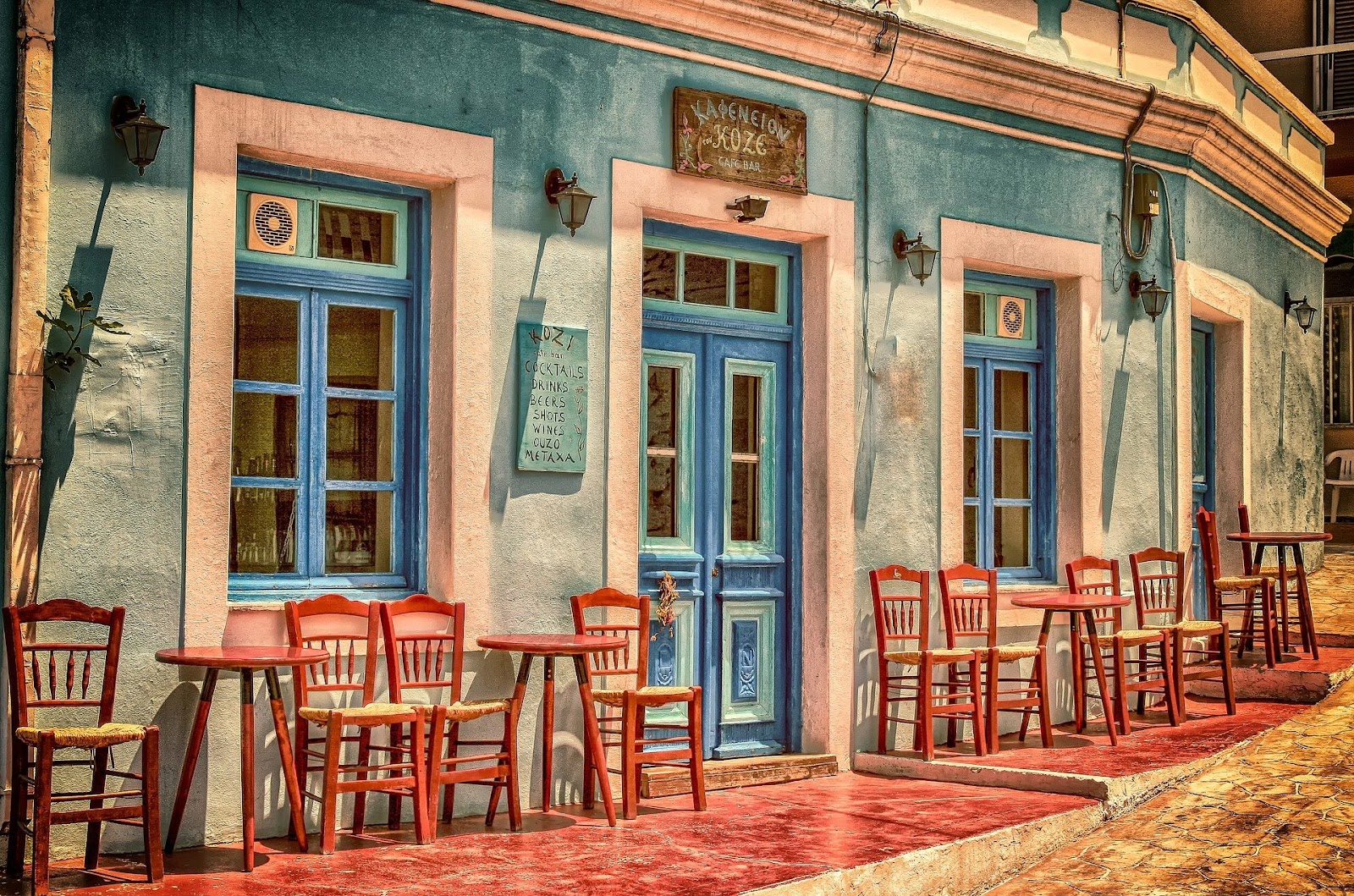 Blue cafe exterior with red painted chairs